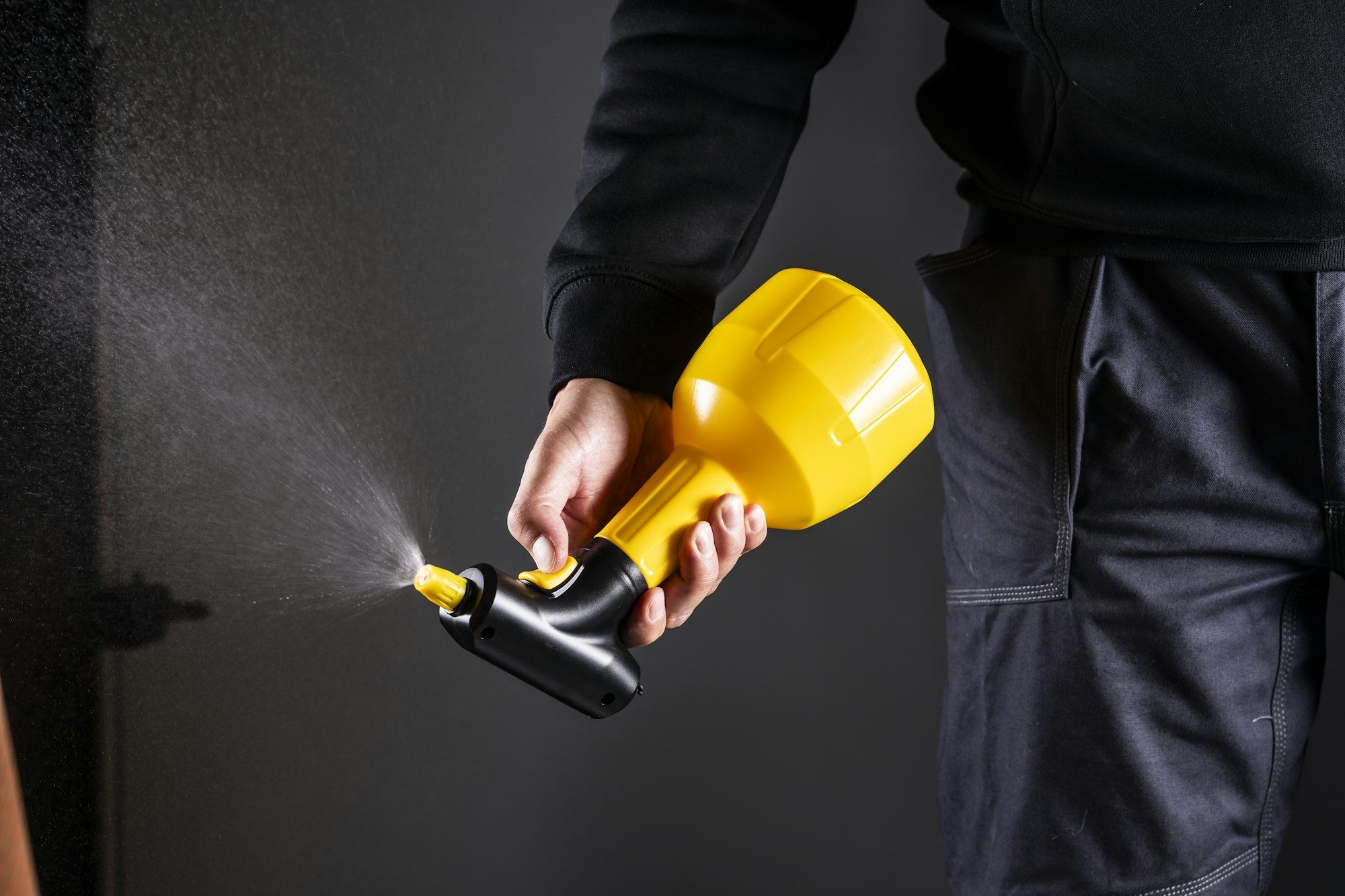 A hand-held pump sprayer releasing a fine mist