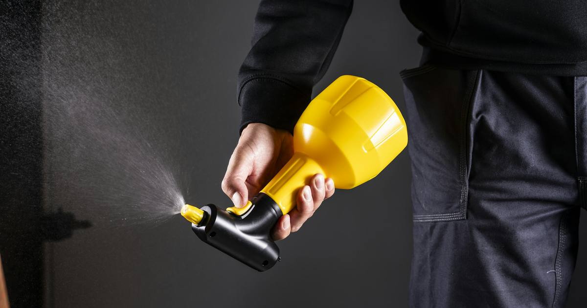 A hand-held pump sprayer releasing a fine mist